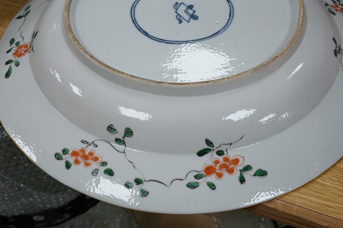 A near pair of Samson famille verte powder blue dishes in Chinese export style, each painted with a pheasant flying above blossoming branches and rocks, the border set with eight floral cartouches, underglaze blue ribbon